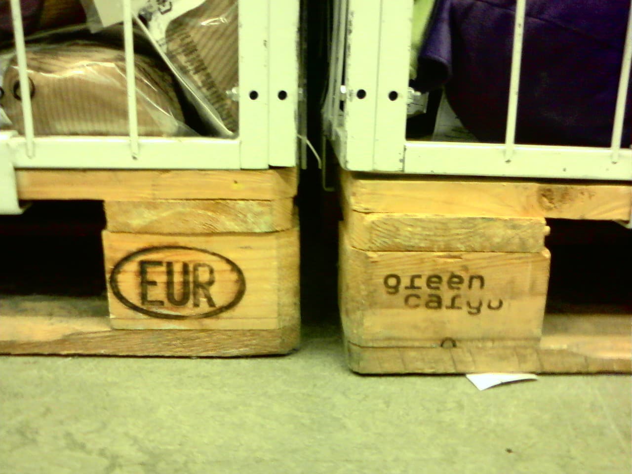 Used engine being secured to shipping pallet with straps and bracing