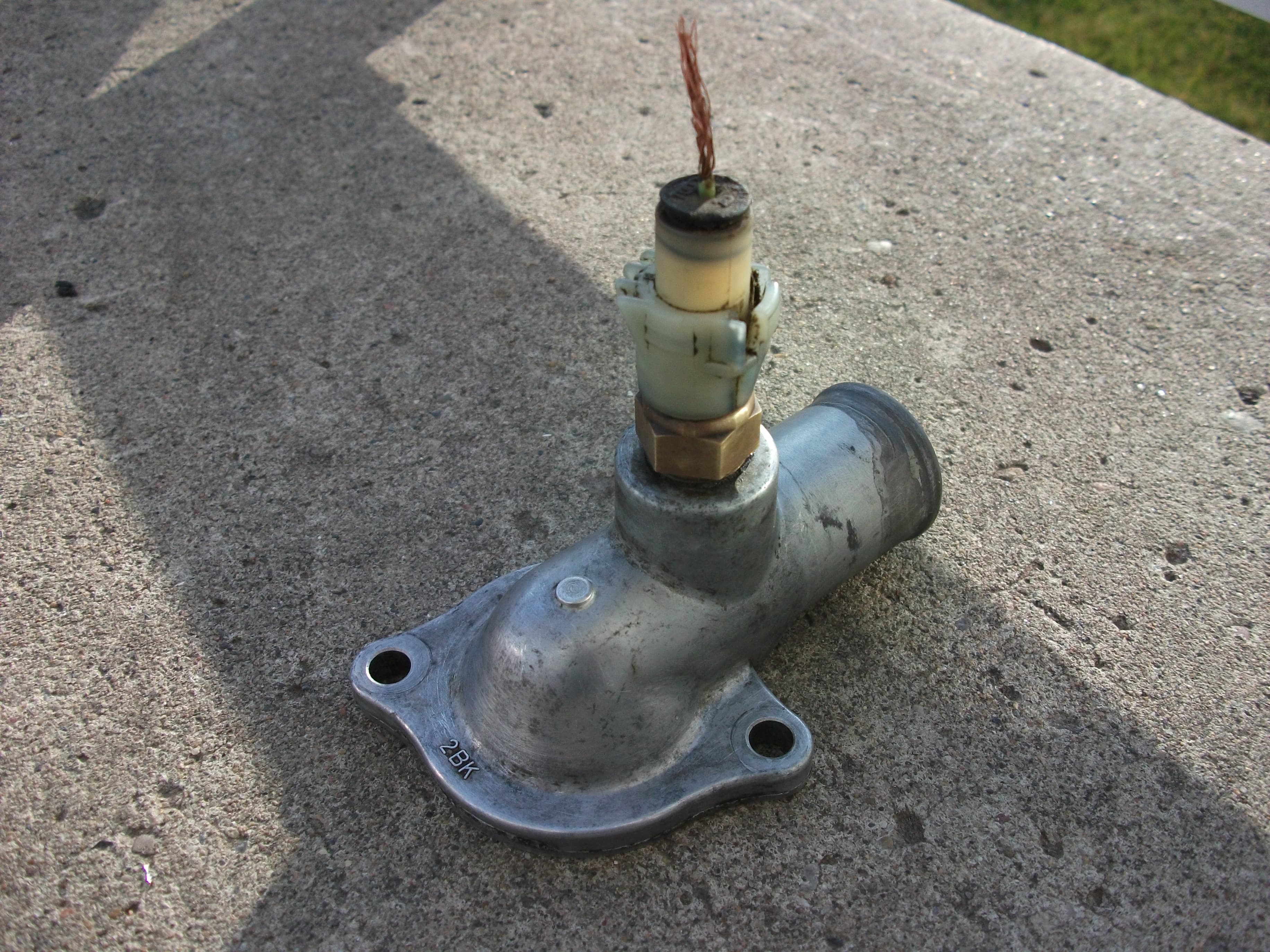 Close-up of OEM manufacturer marking stamp on genuine auto part