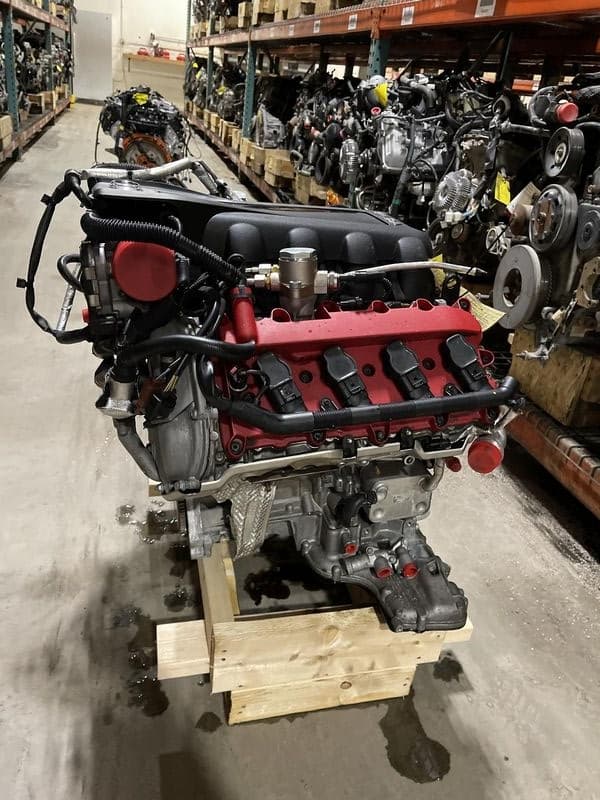 Tested automotive engine strapped to a wooden pallet prepared for nationwide LTL freight delivery