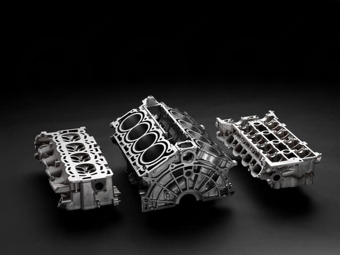 Short block engine assembly showing bare block with crankshaft and pistons